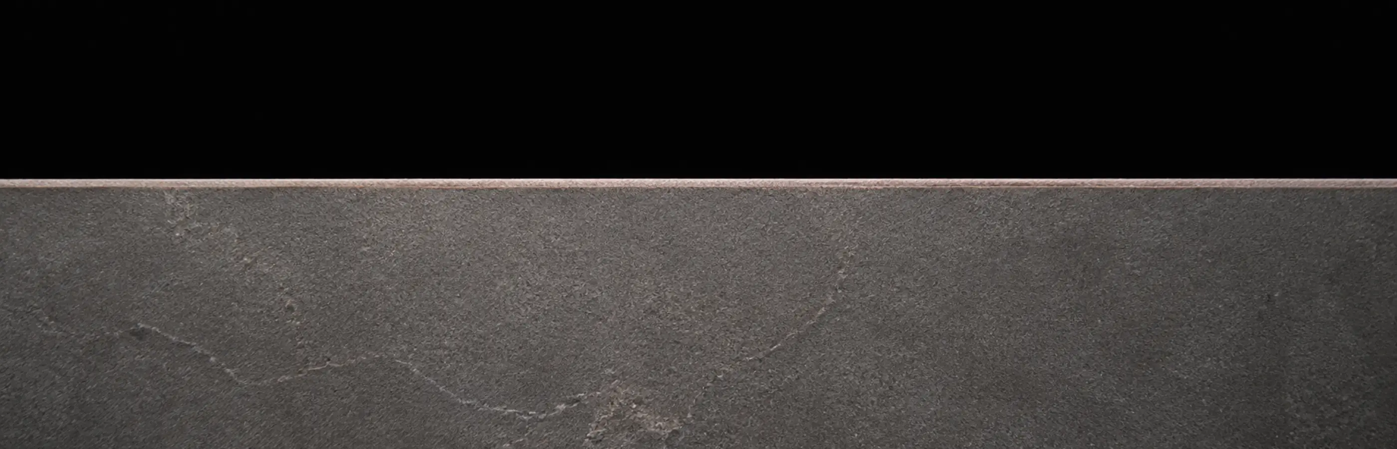 The edge of a stone surface in natural light